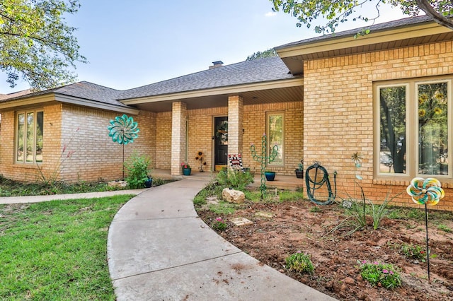 view of exterior entry with covered porch