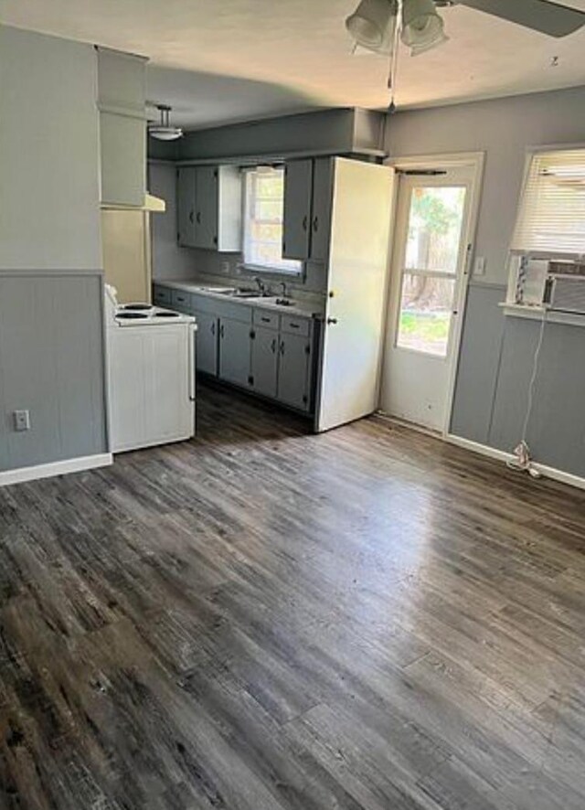 kitchen featuring gray cabinets, ceiling fan, white range with electric cooktop, cooling unit, and dark hardwood / wood-style flooring