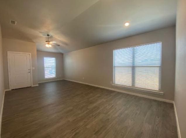 spare room featuring dark hardwood / wood-style floors and ceiling fan