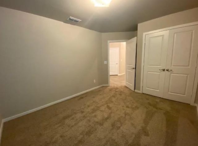 unfurnished bedroom with a closet and carpet