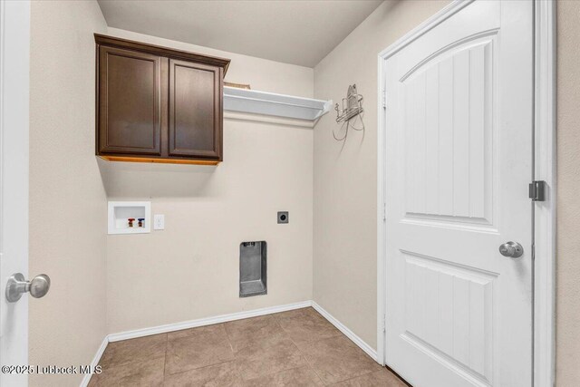 7024 34th Pl, Lubbock, TX 79407 - laundry area with hookup for a washing machine, baseboards, electric dryer hookup, and cabinet space