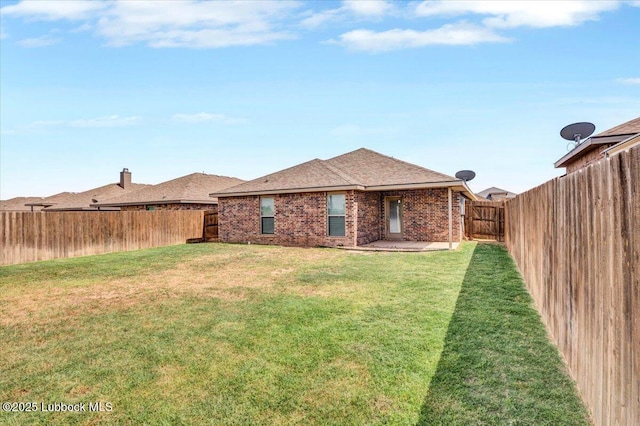 7024 34th Pl, Lubbock, TX 79407 - rear view of house with brick siding, a shingled roof, and a patio area