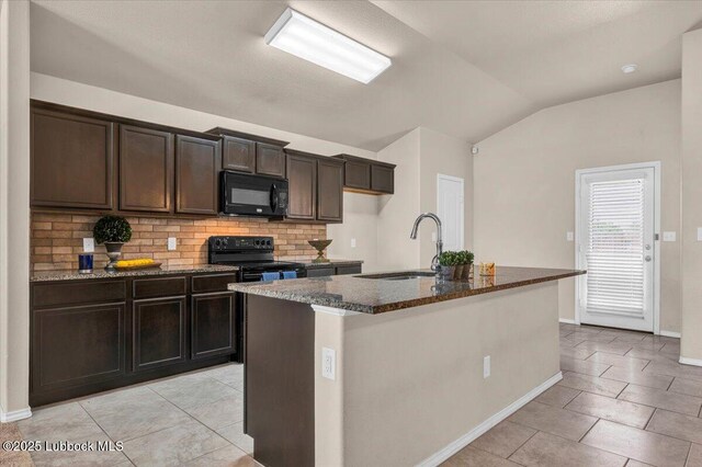 7024 34th Pl, Lubbock, TX 79407 - kitchen with black appliances, vaulted ceiling, dark stone countertops, tasteful backsplash, and light tile patterned floors
