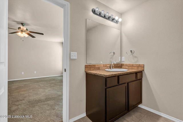 7024 34th Pl, Lubbock, TX 79407 - bathroom featuring vanity, a ceiling fan, and baseboards
