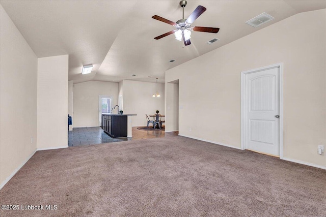 7024 34th Pl, Lubbock, TX 79407 - unfurnished living room featuring lofted ceiling, carpet flooring, ceiling fan, baseboards, and a sink