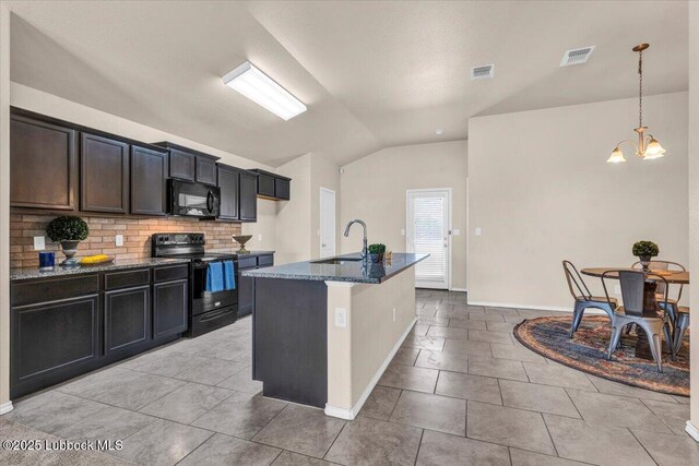 7024 34th Pl, Lubbock, TX 79407 - kitchen featuring black appliances, a sink, vaulted ceiling, dark stone counters, and tasteful backsplash
