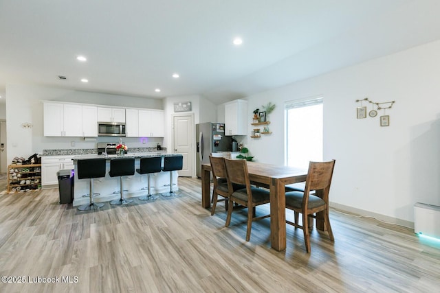7415 8th St, Lubbock, TX 79416 - dining space featuring light wood-type flooring, recessed lighting, baseboards, and a baseboard heating unit