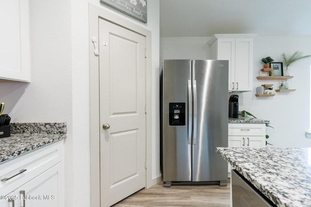 7415 8th St, Lubbock, TX 79416 - kitchen with stainless steel fridge with ice dispenser, white cabinets, light stone counters, and open shelves