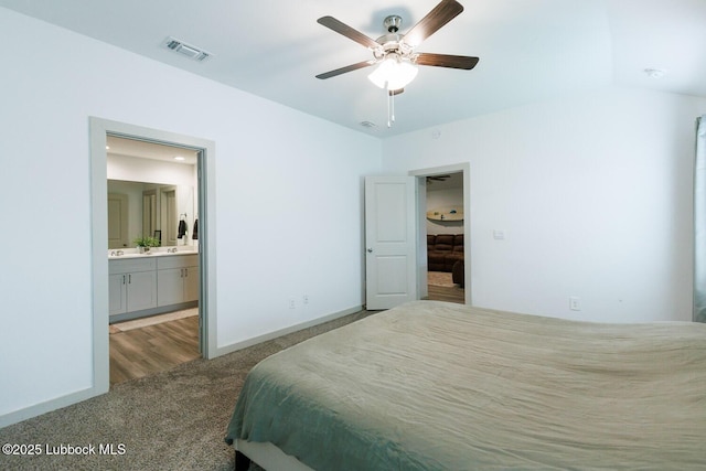 7415 8th St, Lubbock, TX 79416 - bedroom with carpet, ensuite bath, and baseboards