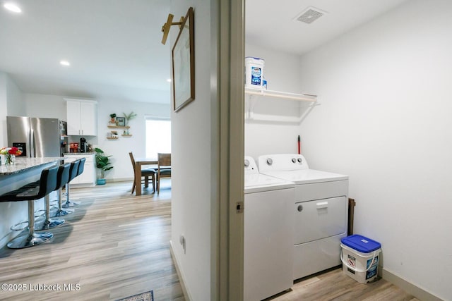 7415 8th St, Lubbock, TX 79416 - laundry room featuring washing machine and clothes dryer, light wood-style floors, baseboards, and recessed lighting