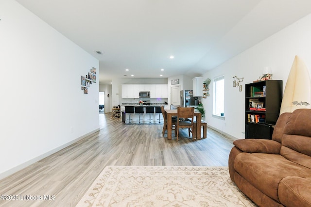 7415 8th St, Lubbock, TX 79416 - living room with light wood-style flooring, recessed lighting, and baseboards