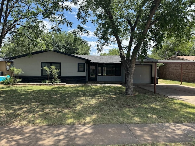 ranch-style home featuring a garage and a front lawn