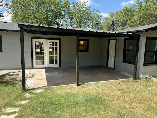 exterior space with french doors, a yard, and a patio