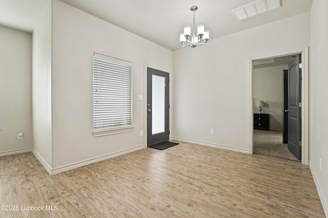 5303 Lehigh St, Lubbock, TX 79416 - entryway featuring a chandelier, wood finished floors, and baseboards