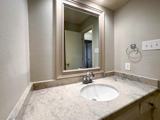 bathroom with vanity and a textured ceiling