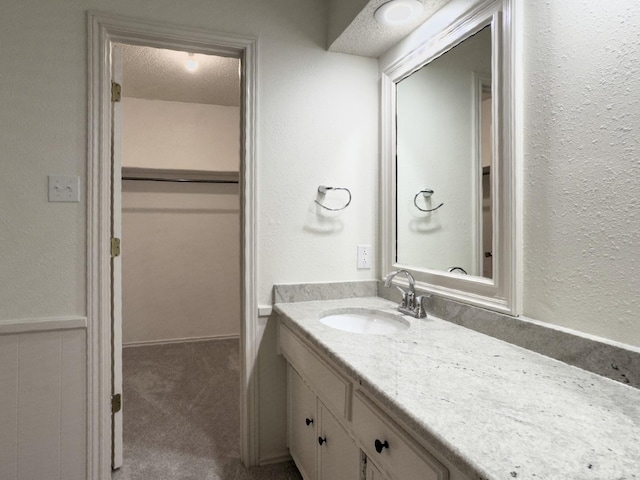 bathroom with vanity and a textured ceiling