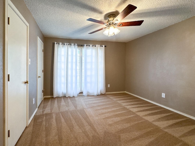 unfurnished bedroom with carpet floors, a textured ceiling, and ceiling fan