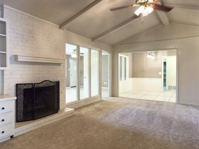 unfurnished living room with a fireplace, lofted ceiling with beams, ceiling fan, light carpet, and a textured ceiling