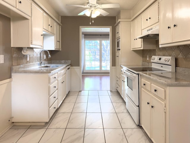 kitchen featuring white cabinetry, white appliances, sink, and tasteful backsplash