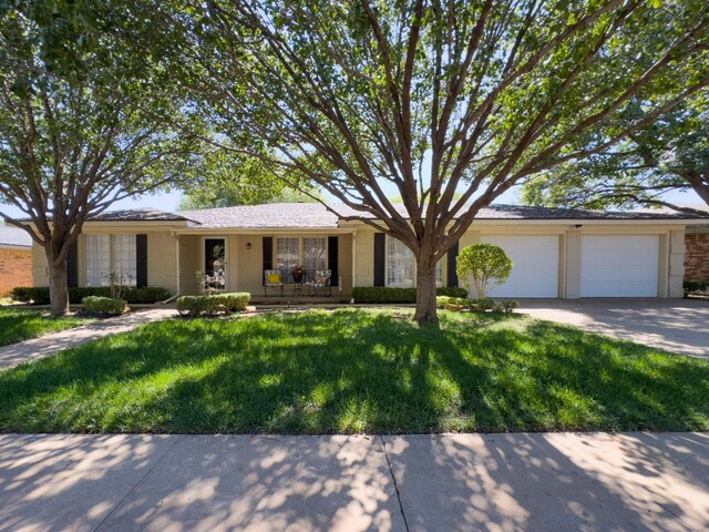 ranch-style house with a garage and a front yard