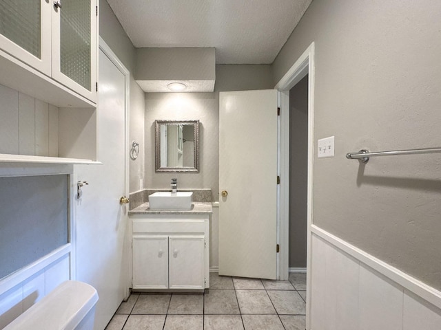 bathroom with tile patterned flooring and vanity