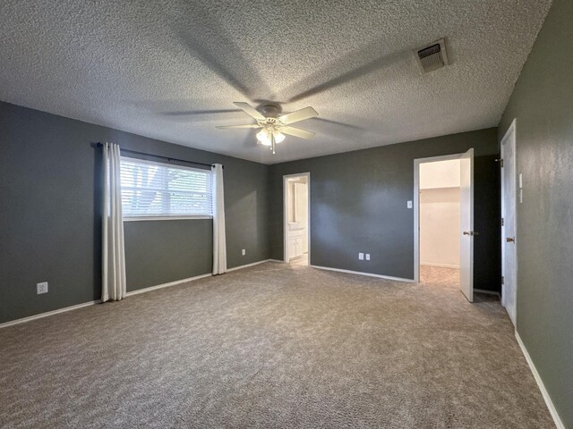 unfurnished bedroom featuring ceiling fan and carpet