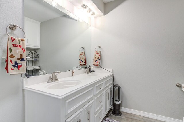 bathroom with vanity and hardwood / wood-style floors