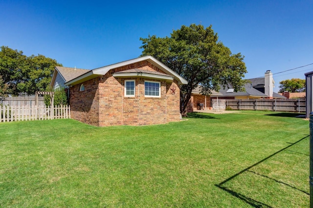 view of side of home with a lawn