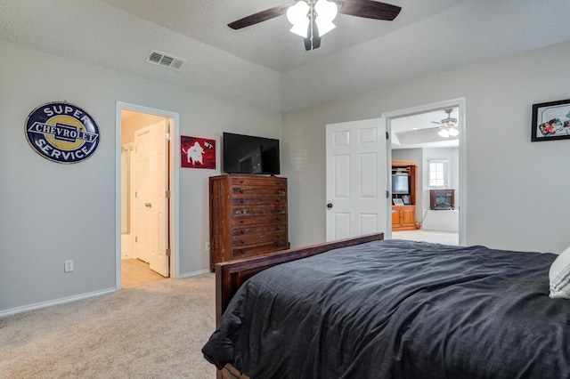 carpeted bedroom with ensuite bath, vaulted ceiling, a textured ceiling, and ceiling fan