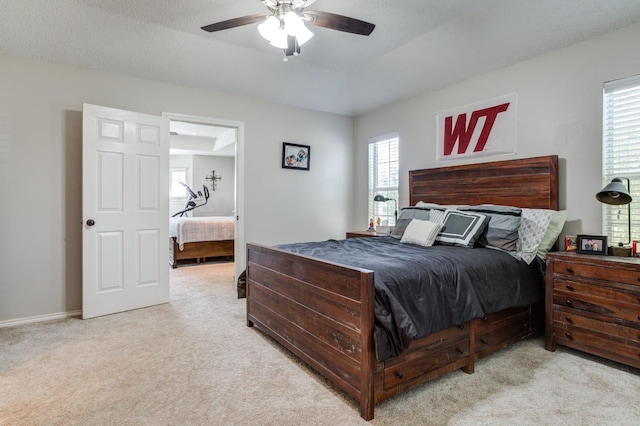 carpeted bedroom featuring a textured ceiling and ceiling fan