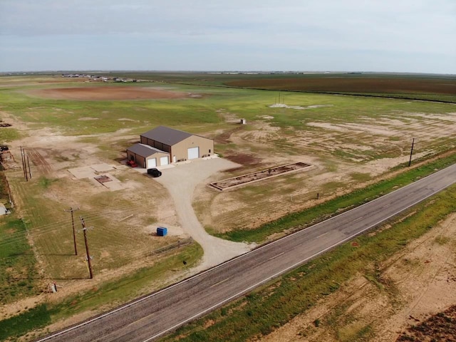 birds eye view of property with a rural view