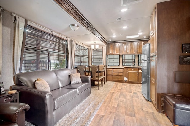 living room with sink and light wood-type flooring