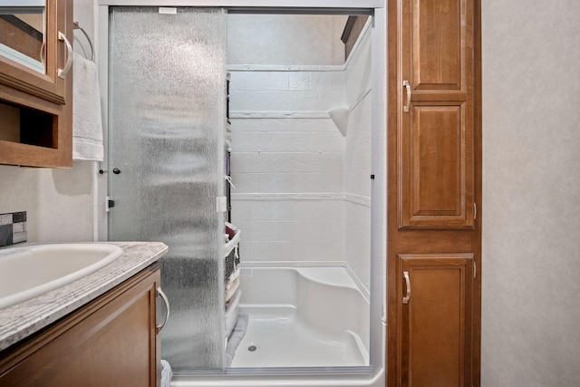 bathroom featuring a shower and vanity