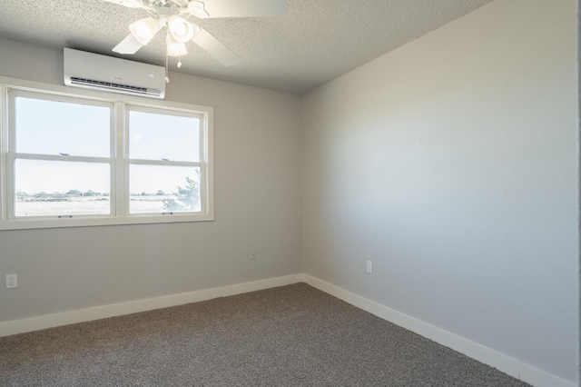 carpeted empty room featuring ceiling fan, a wall mounted AC, and a textured ceiling