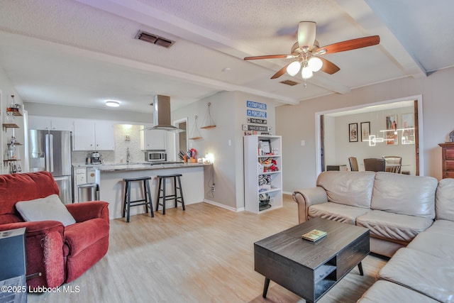 4816 55th St, Lubbock, TX 79414 - living area with beamed ceiling, ceiling fan, light wood finished floors, and baseboards