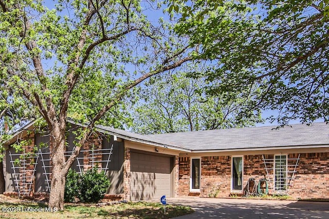 4816 55th St, Lubbock, TX 79414 - view of front of property featuring brick siding, an attached garage, and driveway