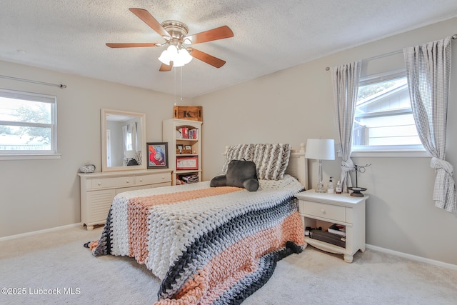 4816 55th St, Lubbock, TX 79414 - bedroom with light carpet, a textured ceiling, a ceiling fan, and baseboards
