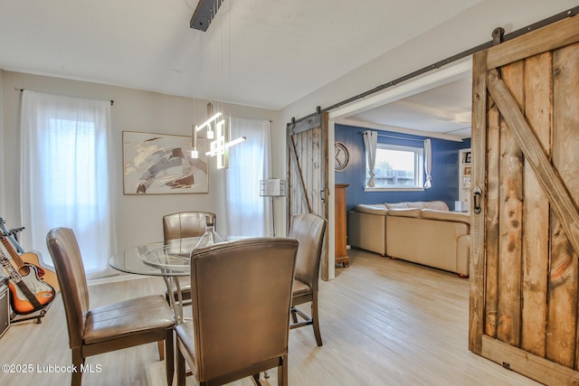 4816 55th St, Lubbock, TX 79414 - dining room featuring a barn door and light wood finished floors
