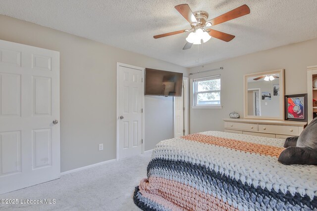 4816 55th St, Lubbock, TX 79414 - carpeted bedroom with a textured ceiling, a ceiling fan, and baseboards