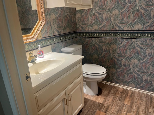 bathroom featuring hardwood / wood-style flooring, vanity, and toilet