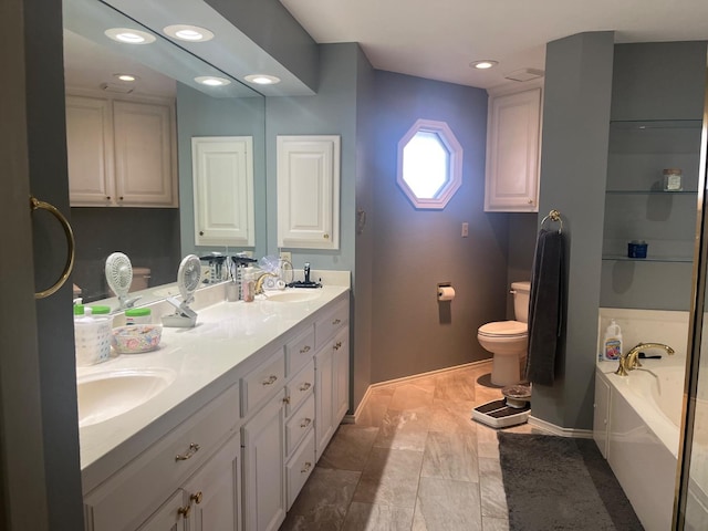 bathroom with vanity, a bath, and toilet