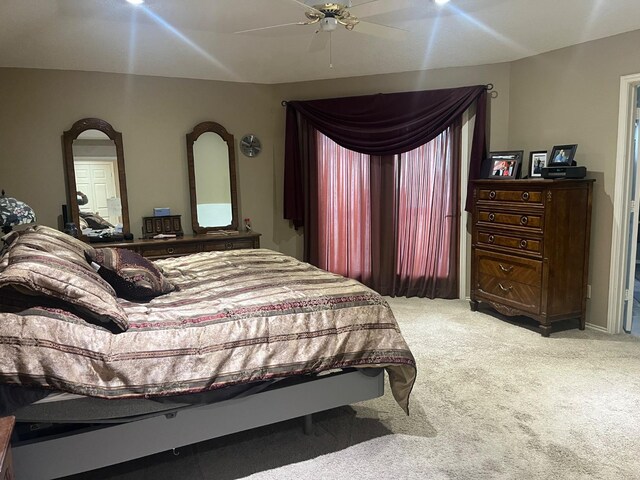 bedroom with ceiling fan and light carpet