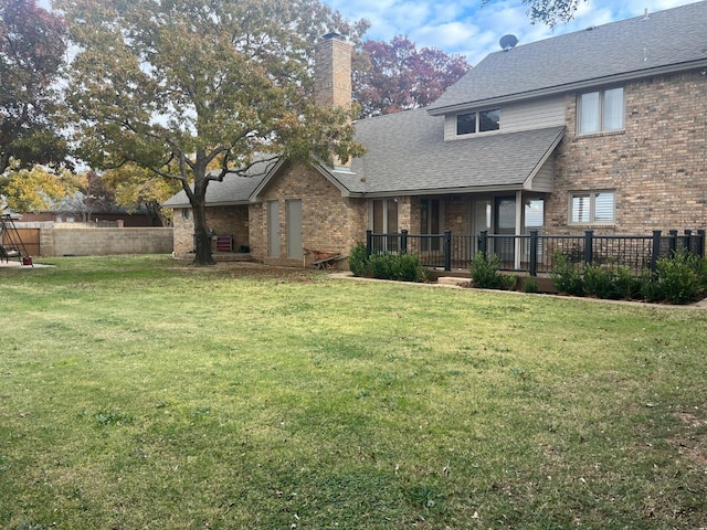 back of property featuring a yard