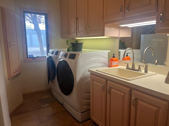 laundry room featuring washer and dryer, sink, and cabinets