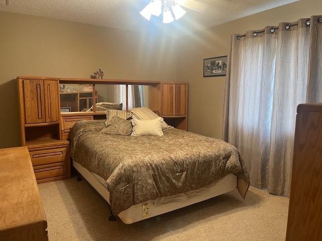 bedroom featuring lofted ceiling, light colored carpet, and a textured ceiling