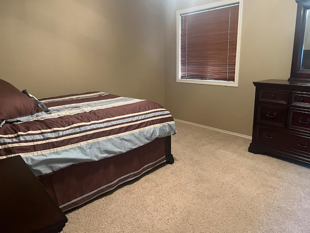 bedroom featuring light carpet