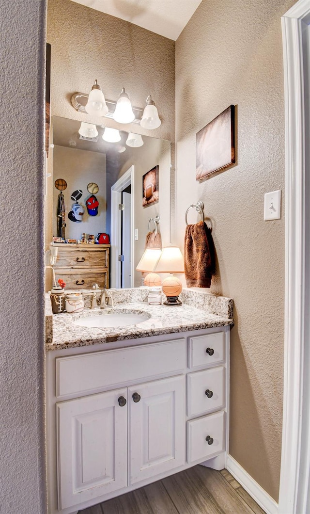 bathroom with vanity and hardwood / wood-style floors