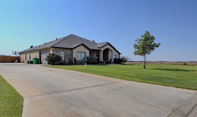 view of front of house featuring a garage and a front yard