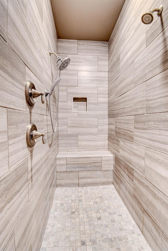 bathroom with tiled shower