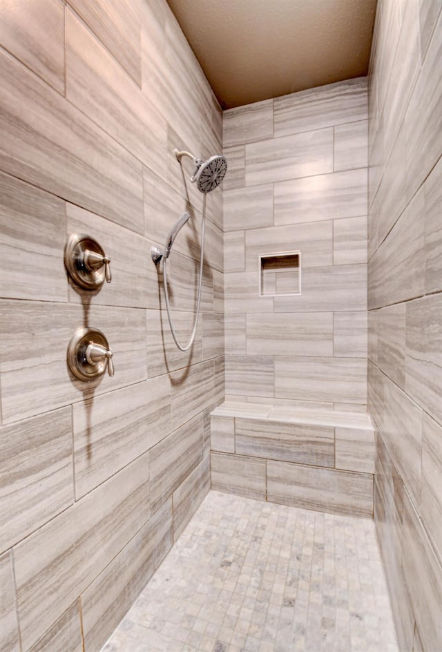 bathroom with tiled shower